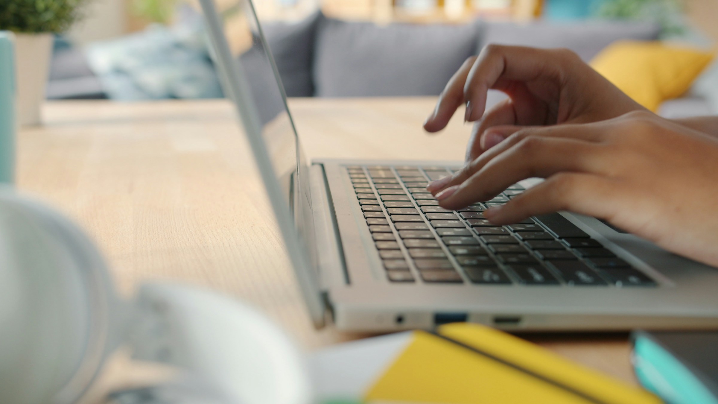 Clinician documenting a behavioral health session in the Auxo EHR on a laptop